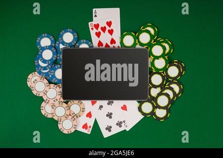 Online poker game with digital tablet, chips and cards Stock Photo