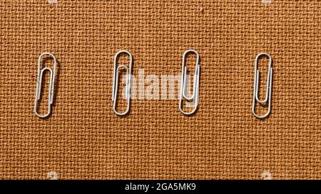 Four James paper clip blinder lying in a row on Brown Color Hard cork board. Stock Photo