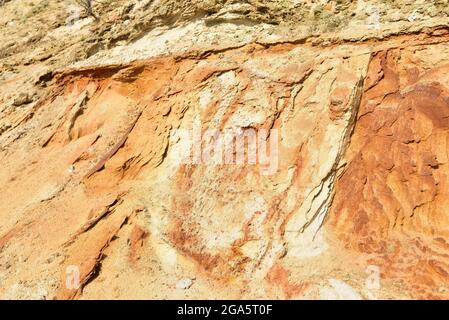 Land structure in open pit mining. Ground background in quarry. Rock texture during earthworks. Sand background and Earth's crust. Stock Photo