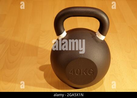 Heavy kettlebell on wooden background Stock Photo