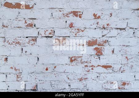 Old white brick wall with stained aged bricks. Urban background, white ruined industrial brick wall texture Stock Photo