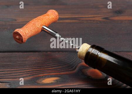Bottle opener close-up, on wooden background Stock Photo