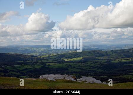 Gathering cumulus clouds on a summer's afternoon, throwing shadows over rolling Welsh hills Stock Photo