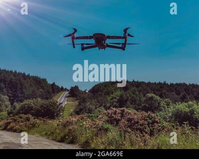 DJI Mavic Pro 2 Drone Flying in a forest Countryside Stock Photo
