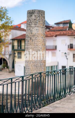 Chaves, Portugal. August 21, 2020. Roman inscription on a column. Touristic and historic landmark, stone roman bridge on the Tamega river. Also known Stock Photo