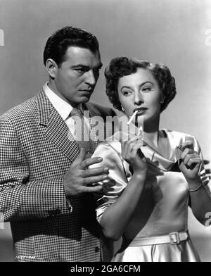 BARBARA STANWYCK and STEPHEN McNALLY posed publicity portrait in THE LADY GAMBLES 1949 director MICHAEL GORDON story Lewis Meltzer gowns Orry-Kelly Universal International Pictures (UI) Stock Photo