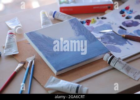 Notebook and paints on the desk Stock Photo