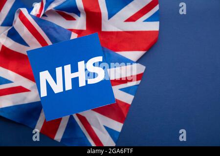 LONDON, UK - July 2021: NHS National health service logo on a union jack flag Stock Photo