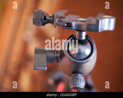 Tripod head for the camera, close-up. A tripod head is the part of a tripod system that attaches the supported device to the tripod legs. Stock Photo