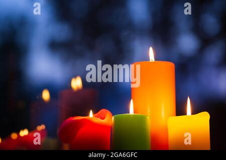 Candle lights in the evening, reflections in the window Stock Photo