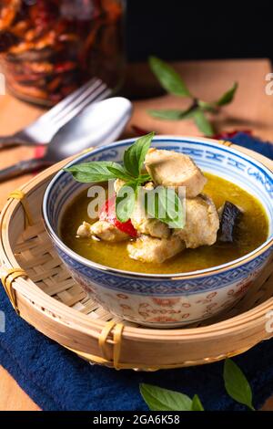 Food concept homemade Thai chicken green curry on wooden board with copy space Stock Photo