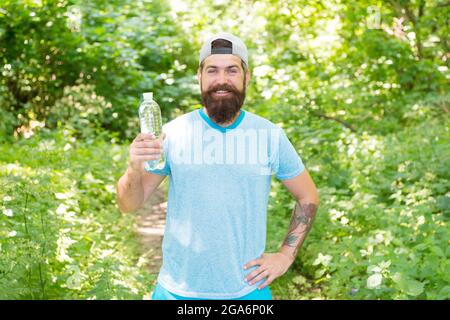 jogging drinking water. guy maintains body water balance. hydration. daily water. Stock Photo