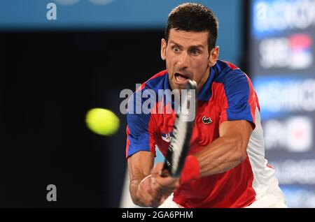 Tokio, Japan. 29th July, 2021. Tennis: Olympics, preliminary, singles, men, quarter-finals, Djokovic (Serbia) - Nishikori (Japan) at Ariake Tennis Park. Novak Djokovic plays a backhand. Credit: Swen Pförtner/dpa/Alamy Live News Stock Photo