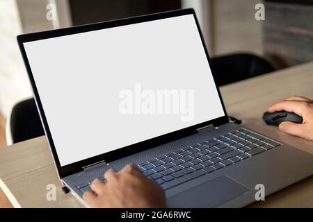 Rear view of business man hands busy using laptop at office desk, with copyspace Stock Photo