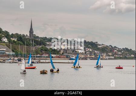 Cobh, County Cork, Ireland. 29th July, 2021. On an overcast and cooler day than late, members of Cove Sailing Club take to the water in their sailing dinghys. Met Éireann has forecast thunderstorms and heavy rain this evening, but the weekend should be dry. Credit: AG News/Alamy Live News Stock Photo
