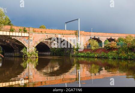 Castlefield Viaduct railway bridge crossing over the River Irwell between Salford and Castlefield, Manchester, north-west England, UK Stock Photo