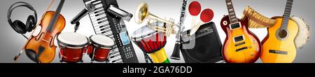 wide panorama collage banner  of various musical instruments. Guitar keyboard Brass percussion studio music concept on grey background Stock Photo