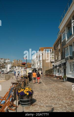 Holidaymakers walking around St Ives harbour in Cornwall, UK. Stock Photo