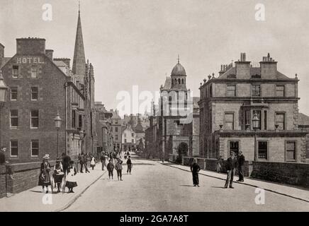 A late 19th century view of Bridge Street in Wick, a town and royal burgh in Caithness, in the far north of Scotland. The town straddles the River Wick and extends along both sides of Wick Bay. Stock Photo