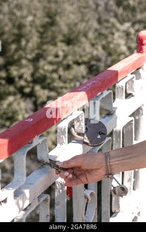 The bride and groom locks. Newlyweds hang the lock symbolizing everlasting love on the wedding day. Wedding tradition. Stock Photo