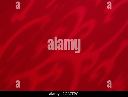 Dark red background with shadows. Abstract ornamental shadows pattern. Elegant exotic background. Close up. Stock Photo