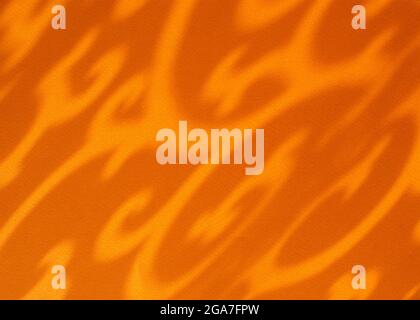 Abstract ornamental shadow on orange paper background. Irregular ethnic pattern. Close up. Stock Photo