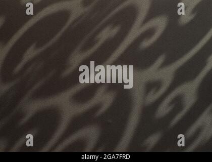 Dark background with shadows. Abstract ornamental shadows pattern. Elegant exotic background. Close up. Stock Photo