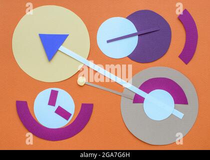 Clocks of different sizes and shapes on orange background. Paper collage. Time concept. Flat lay, top view. Stock Photo