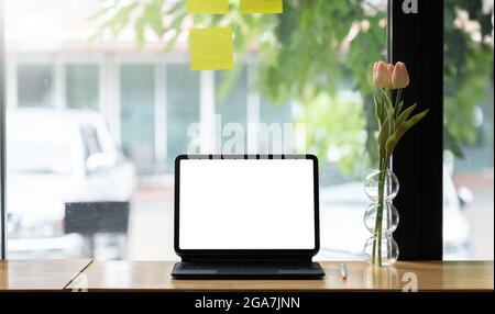 Cropped shot of digital tablet with blank white screen, display for reading informations on mock-up tablet. Stock Photo