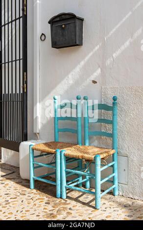 Two chairs in front of white house, Altea Old Town, Spain Stock Photo
