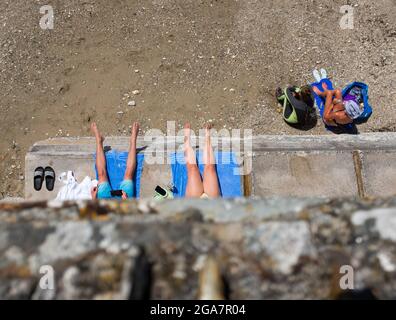 People sunbathing on beach at St Mawes, Cornwall, England, UK Stock Photo
