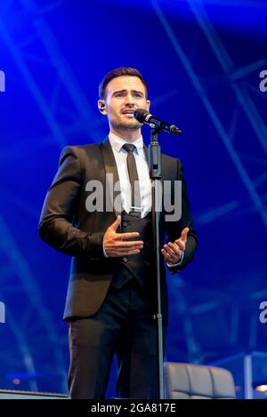 Michael Auger of Collabro performing live at a music festival at Maldon, Essex, UK in July 2021 after COVID restrictions end Stock Photo