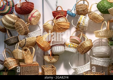 Empty wicker baskets in stock. Collection of various wicker baskets at the fair. Stock Photo