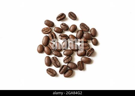 Roasted coffee beans pile isolated on white background. From top view. Roasted coffee beans close-up macro photo Stock Photo
