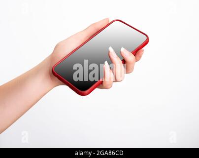 womans hand holding red smartphone with gradiant on white background . mockup . Stock Photo