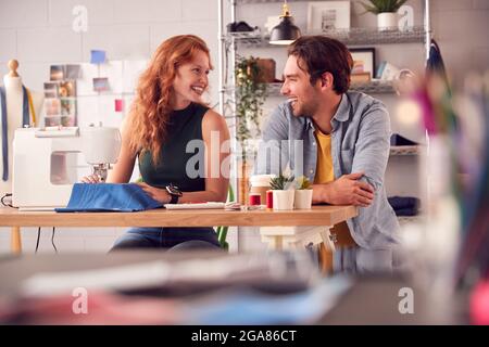 Male And Female Students Or Business Owners Working In Fashion Having Meeting In Studio Stock Photo