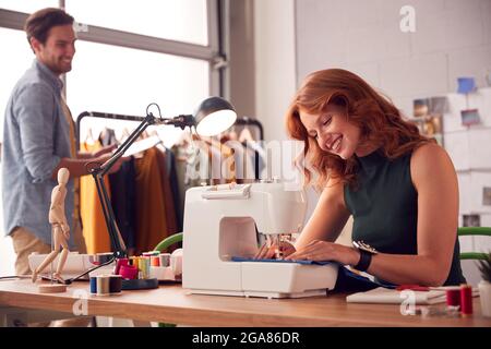 Male And Female Students Or Business Owners Working In Fashion Studio Together Stock Photo