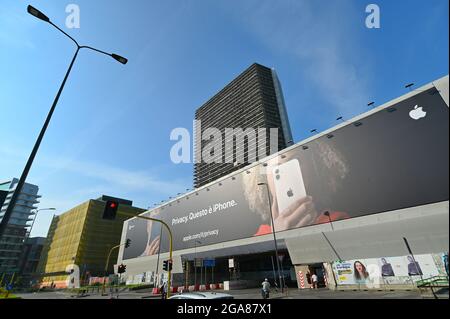 MILANO, ITALY - Jun 12, 2021: A low angle shot of a building facade covered by advertising billboard for Apple iphone in Milan Stock Photo