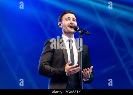 Michael Auger of band Collabro performing live at a music festival at Maldon, Essex, UK in July 2021 after COVID restrictions end Stock Photo