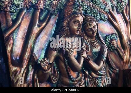 Lord Krishna posing as playing flute and Radha smiling, Goddess Durga with Son Ganesh, decorative terracotta idols made in Krishnanagar, Nadia, West B Stock Photo