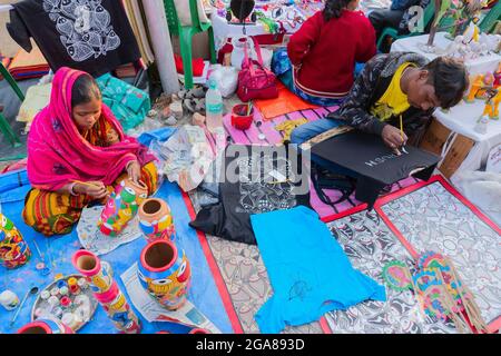 Kolkata, West Bengal, India - 31st December 2018 : Young Bengali male artists painting Pattachitra or Patachitra - traditional, cloth-based scroll pai Stock Photo