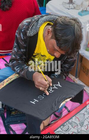 Kolkata, West Bengal, India - 31st December 2018 : Young Bengali artist painting Pattachitra or Patachitra - traditional, cloth-based scroll painting. Stock Photo