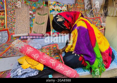 Kolkata, West Bengal, India - 31st December 2018 : Young Bengali female artist painting Pattachitra or Patachitra - traditional, cloth-based scroll pa Stock Photo