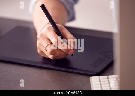Close Up Of Hands Of Male Architect In Office Working On Desktop Computer Using Graphics Tablet Stock Photo