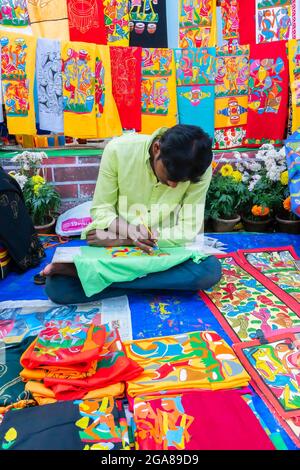 Kolkata, West Bengal, India - 31st December 2018 : Young Bengali artist painting Pattachitra or Patachitra - traditional, cloth-based scroll painting. Stock Photo