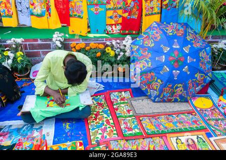 Kolkata, West Bengal, India - 31st December 2018 : Young Bengali artist painting Pattachitra or Patachitra - traditional, cloth-based scroll painting. Stock Photo