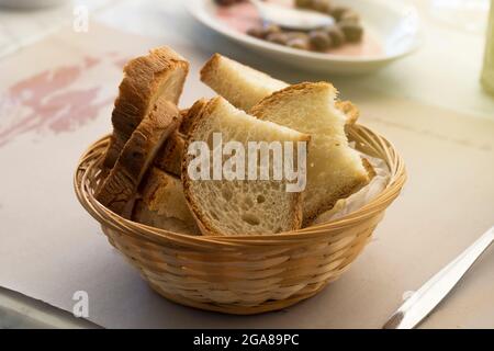Basket of sliced Italian bread on a restaurant table Stock Photo