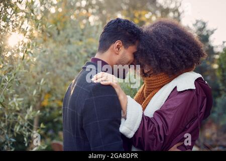 Loving Young Couple Hugging Outdoors In Fall Or Winter Countryside Stock Photo