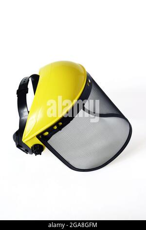 Protective mask with fine mesh, isolated on white background. Case is made of yellow plastic. Eye protection. Close-up. Selective focus. Stock Photo