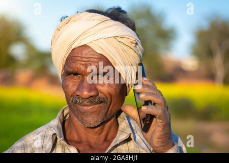 TIKAMGARH, MADHYA PRADESH, INDIA - JULY 23, 2021: Indian farmer standing in agricultural field. Stock Photo